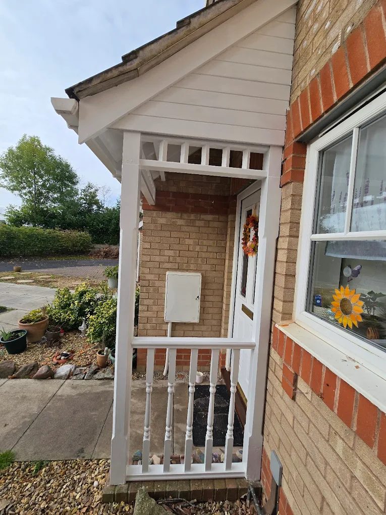 Custom-built timber front porch with balustrade on a Devon home