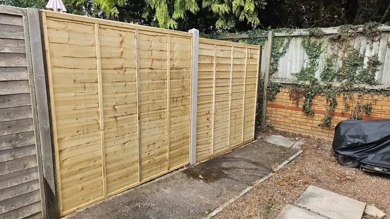 Lap panel fencing with concrete posts fitted in a Cullompton garden